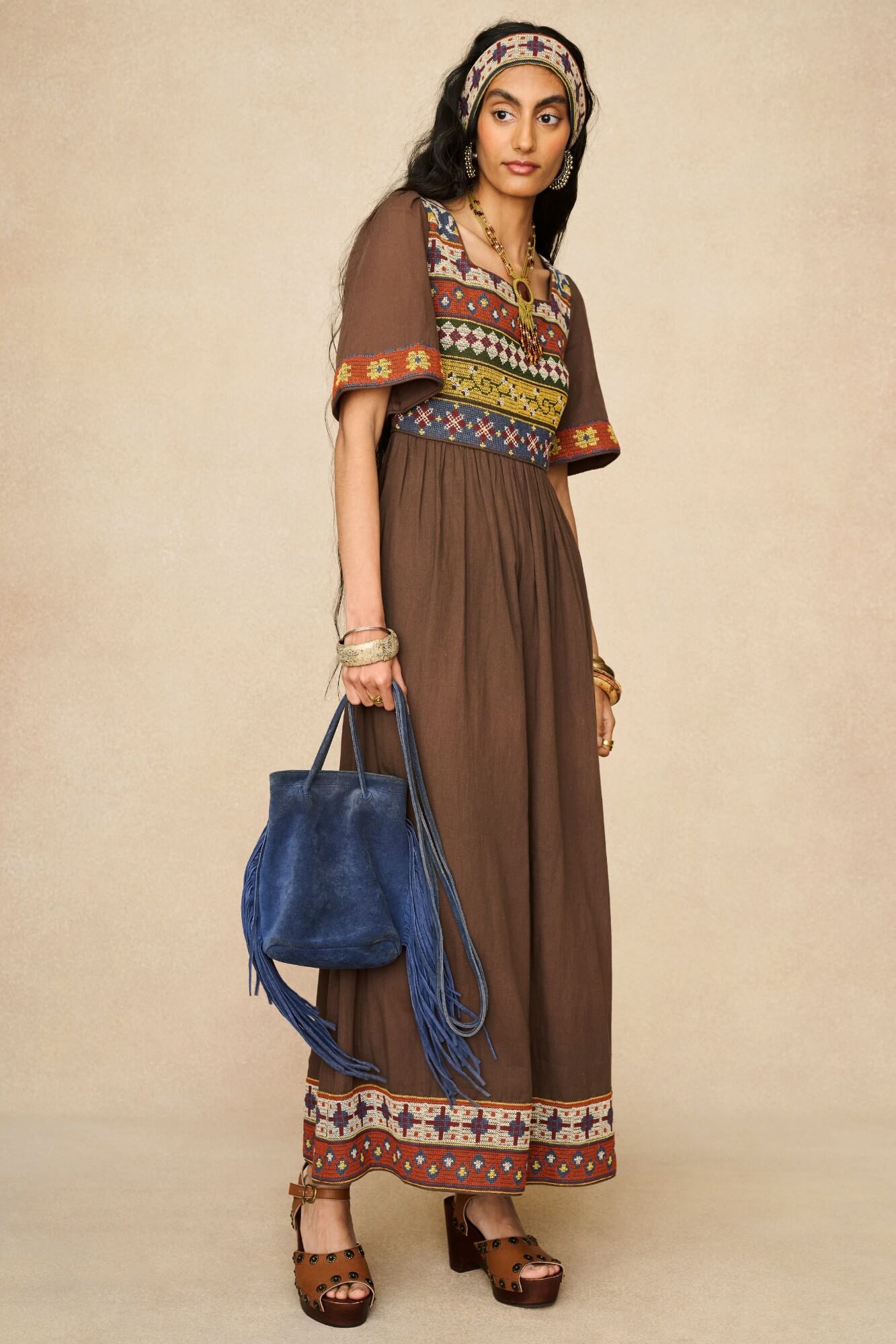 Model wearing brown embroidered maxi dress by The Hippie Shake, front view