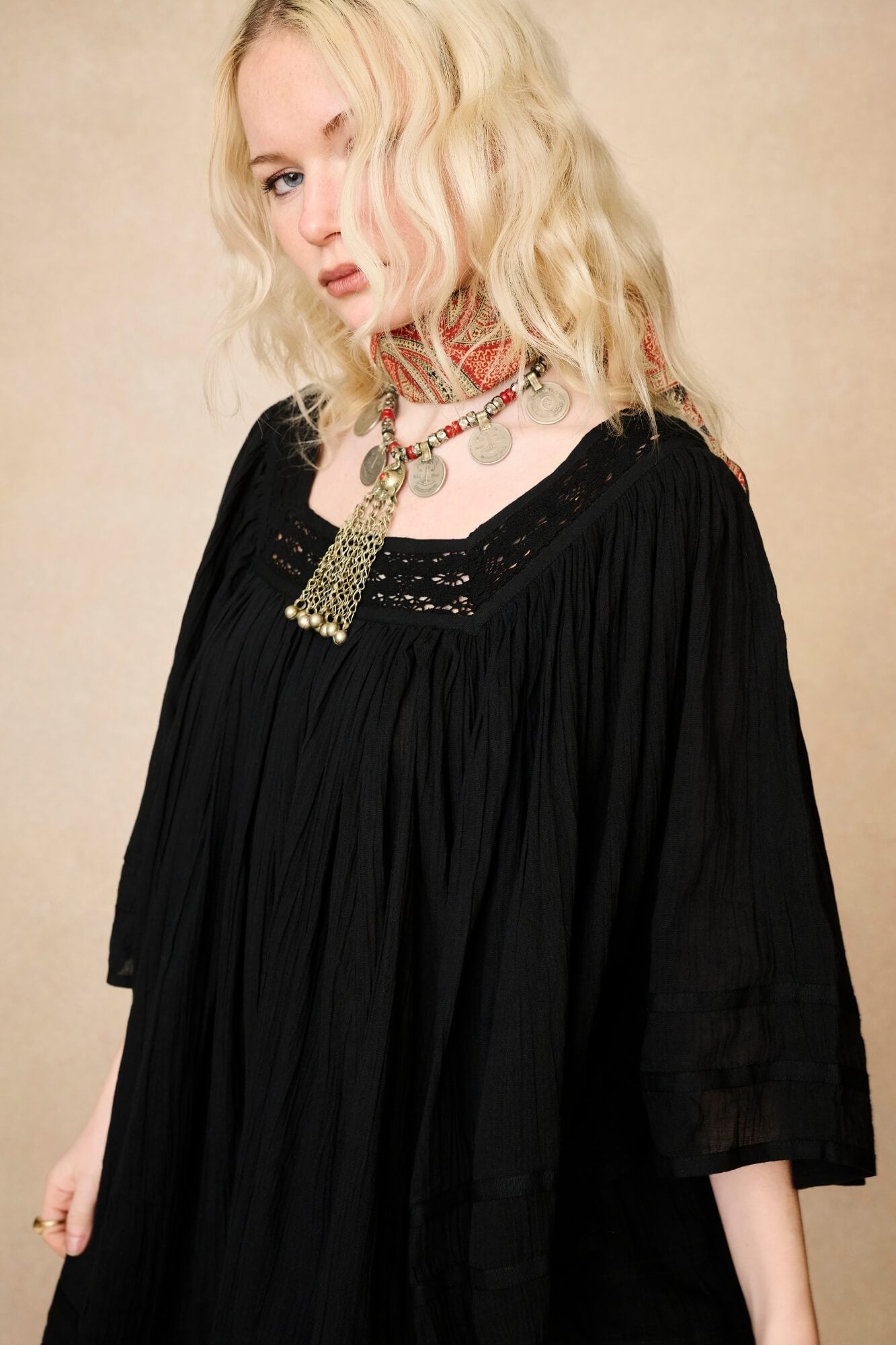 Model wearing 70s black mini dress with lace-up Penny Lane boots by The Hippie Shake, close up view