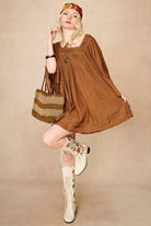 Model wearing 70s brown mini dress with lace-up Penny Lane boots by The Hippie Shake, front view