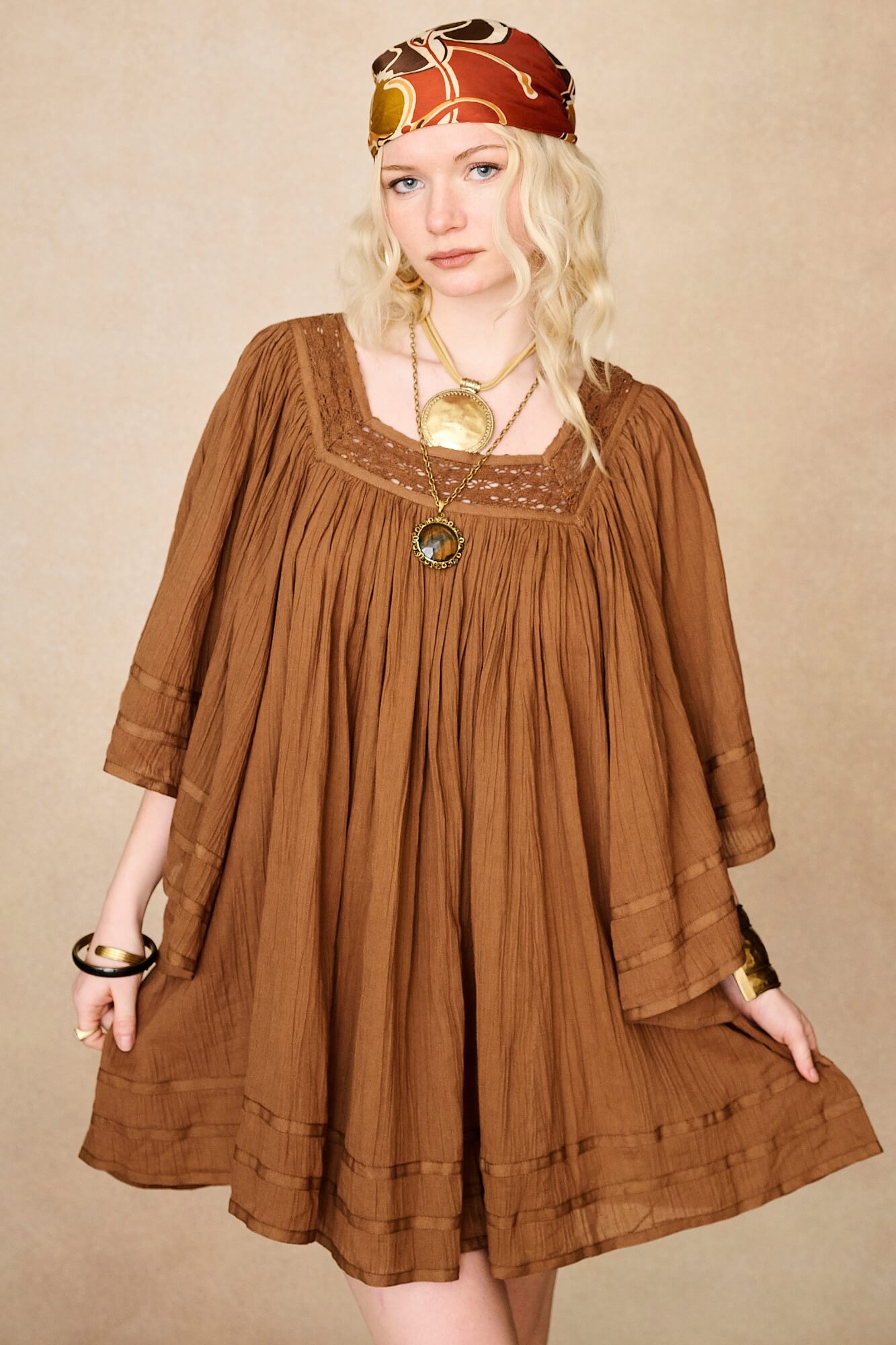 Model wearing 70s brown mini dress with lace-up Penny Lane boots by The Hippie Shake, front view
