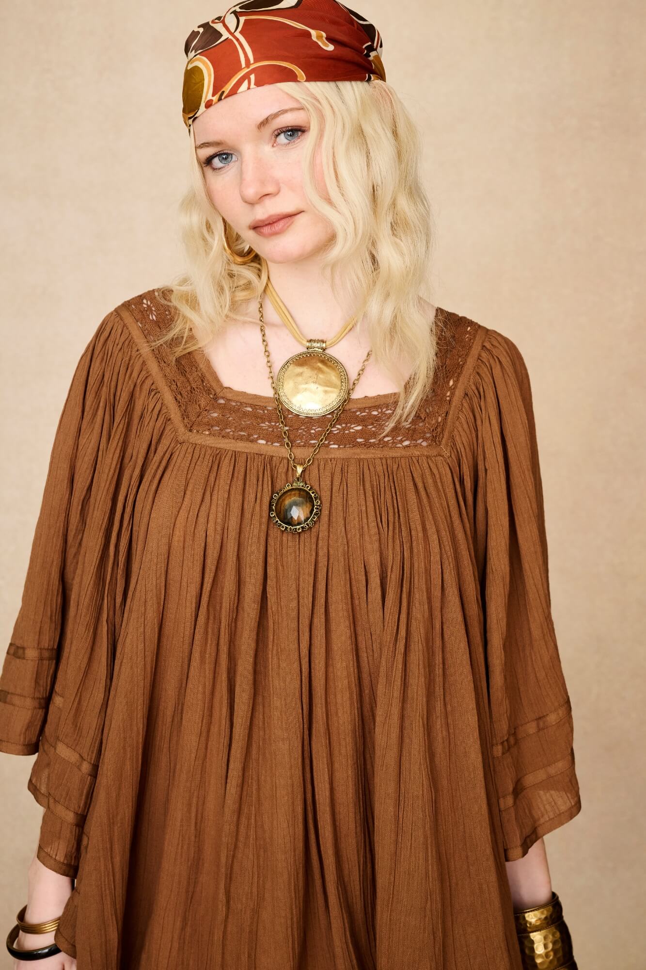 Model wearing 70s brown mini dress with lace-up Penny Lane boots by The Hippie Shake, front close up view