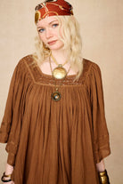 Model wearing 70s brown mini dress with lace-up Penny Lane boots by The Hippie Shake, front close up view