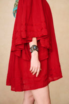 Model wearing 70s red mini dress with lace-up Penny Lane boots by The Hippie Shake, side view