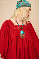 Model wearing 70s red mini dress with lace-up Penny Lane boots by The Hippie Shake, close up shot