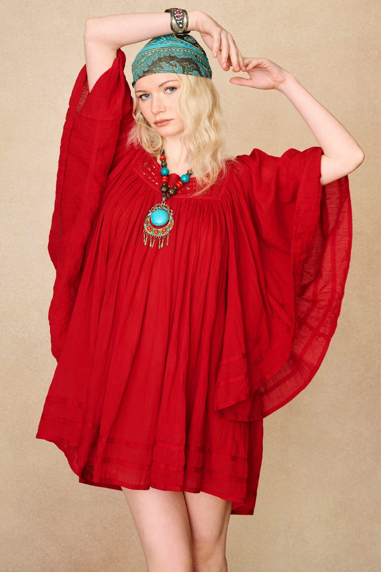 Model wearing 70s red mini dress with lace-up Penny Lane boots by The Hippie Shake, front view