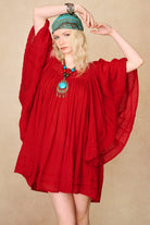 Model wearing 70s red mini dress with lace-up Penny Lane boots by The Hippie Shake, front view