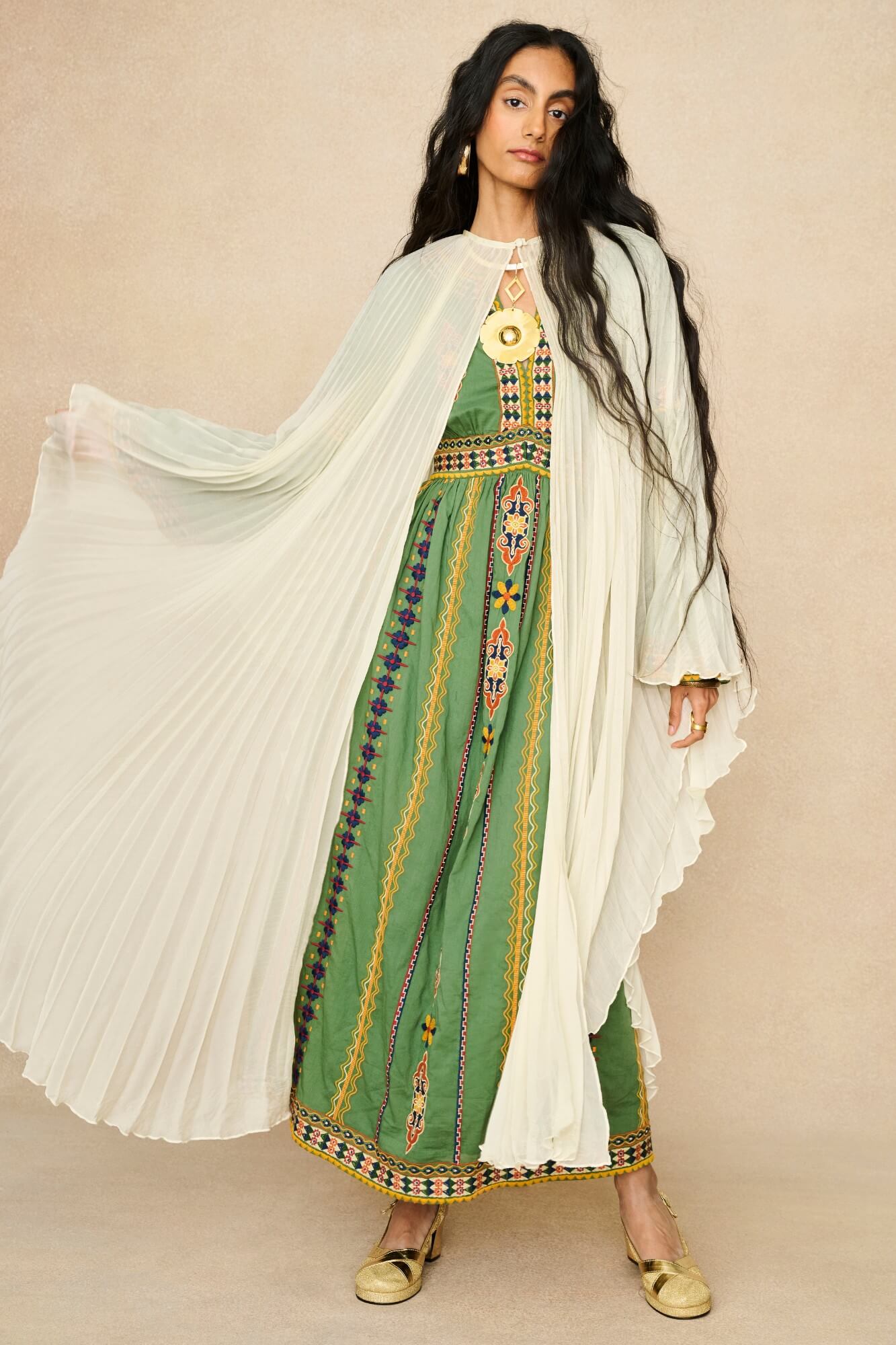 Model wearing 70s cream cape by The Hippie Shake, front view