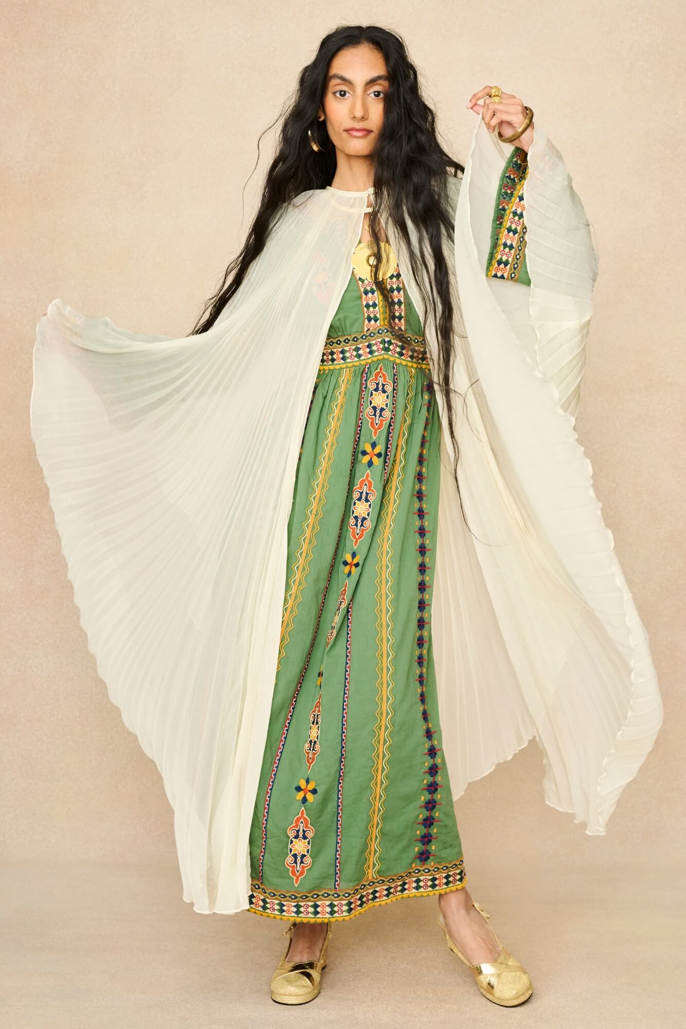 Model wearing 70s cream cape by The Hippie Shake, front view