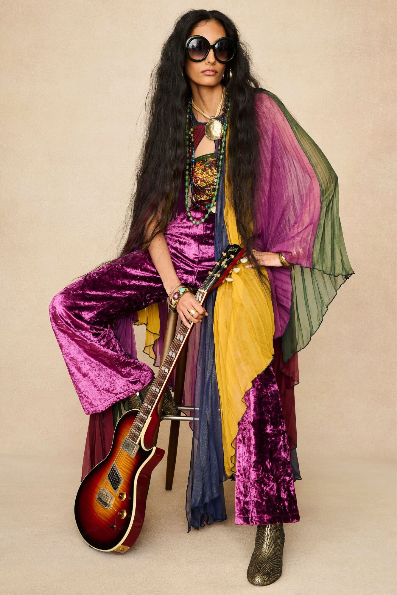 Model wearing rainbow striped cape by The Hippie Shake, front view