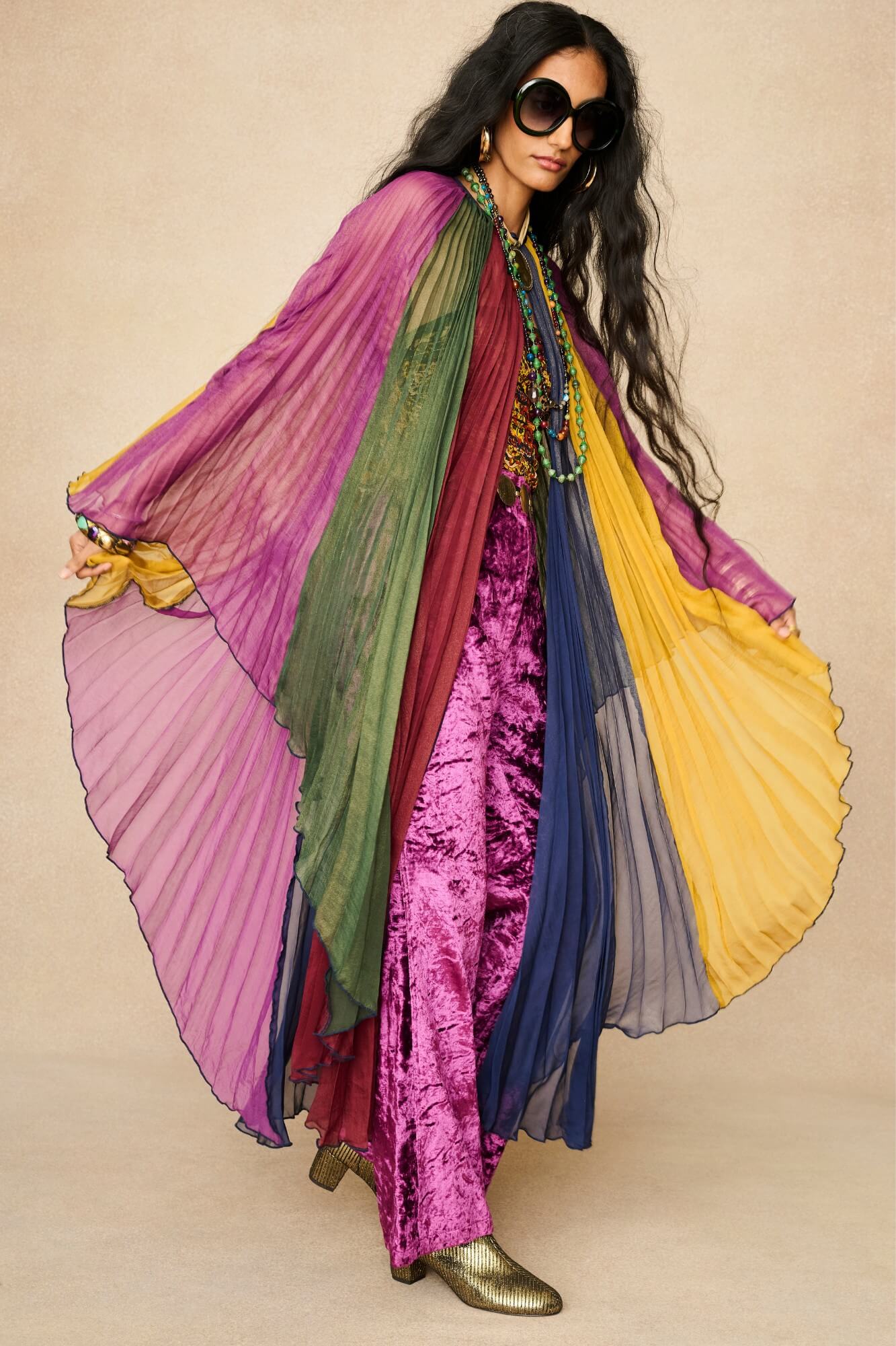 Model wearing rainbow striped cape by The Hippie Shake, front view