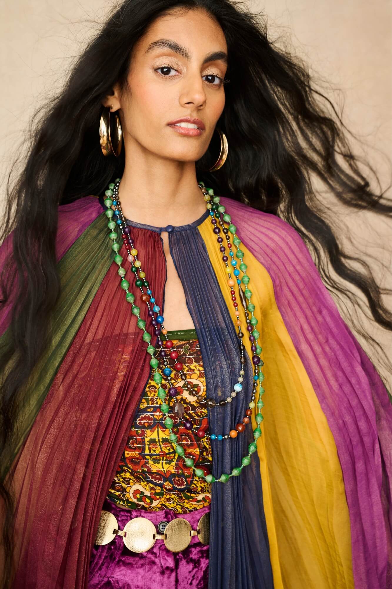Model wearing rainbow striped cape by The Hippie Shake, close up