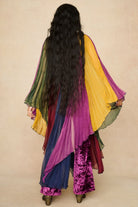 Model wearing rainbow striped cape by The Hippie Shake, back view