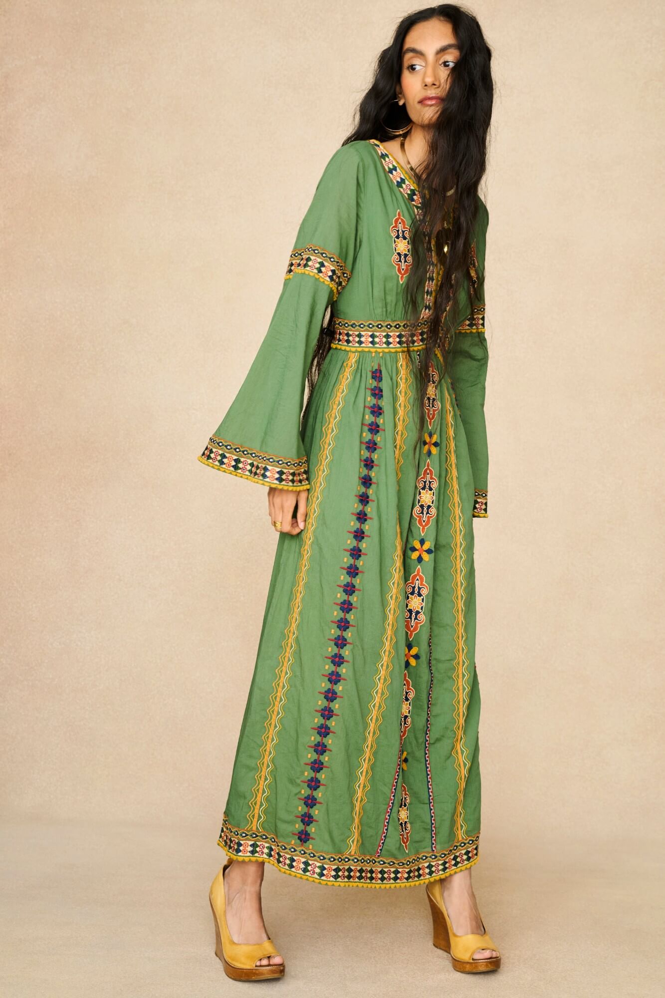 Model wearing 70s green embroidered maxi dress by The Hippie Shake, front view