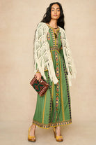 Model wearing 70s green embroidered maxi dress with cream crochet cape by The Hippie Shake, front view