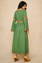 Model wearing 70s green embroidered maxi dress by The Hippie Shake, back view