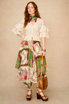 Woman wearing a floral dress with a beige background