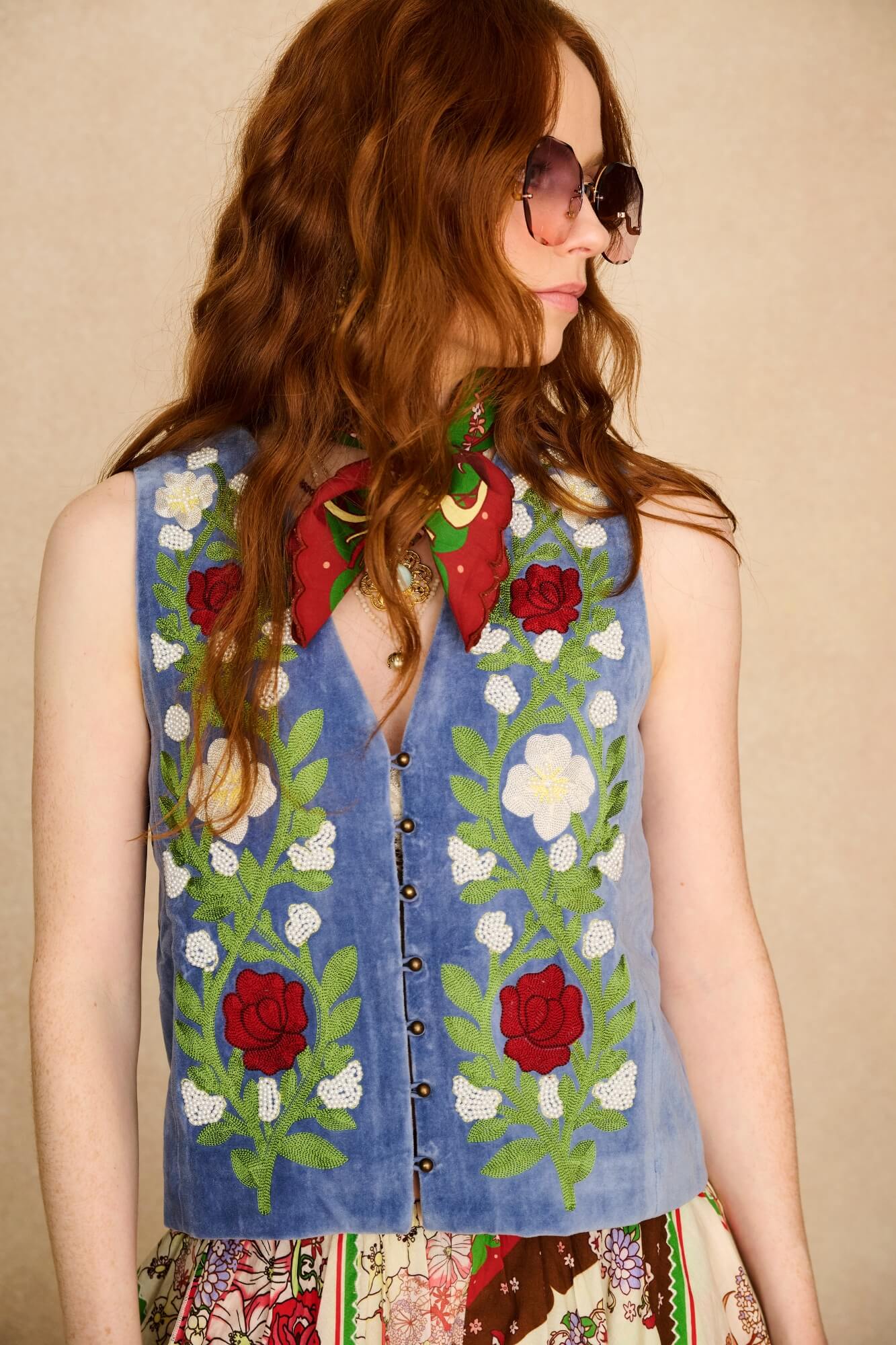 woman wears embroidered blue vest - close up