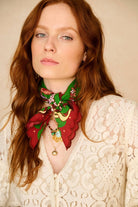 Woman wearing a colorful scarf with a neutral background