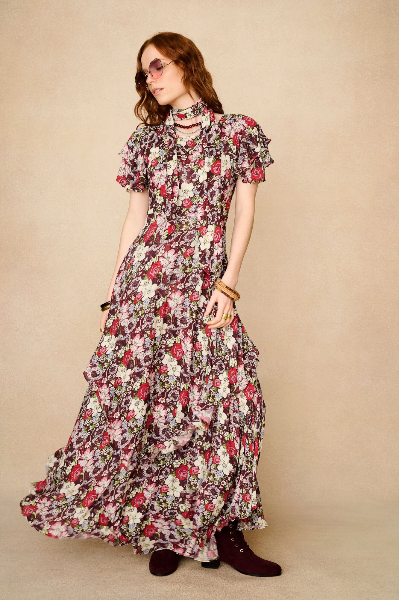 woman wears floral dress with embroidered blue velvet dress
