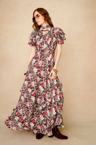 woman wears floral dress with embroidered blue velvet dress