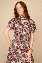 woman wears 70s floral dress