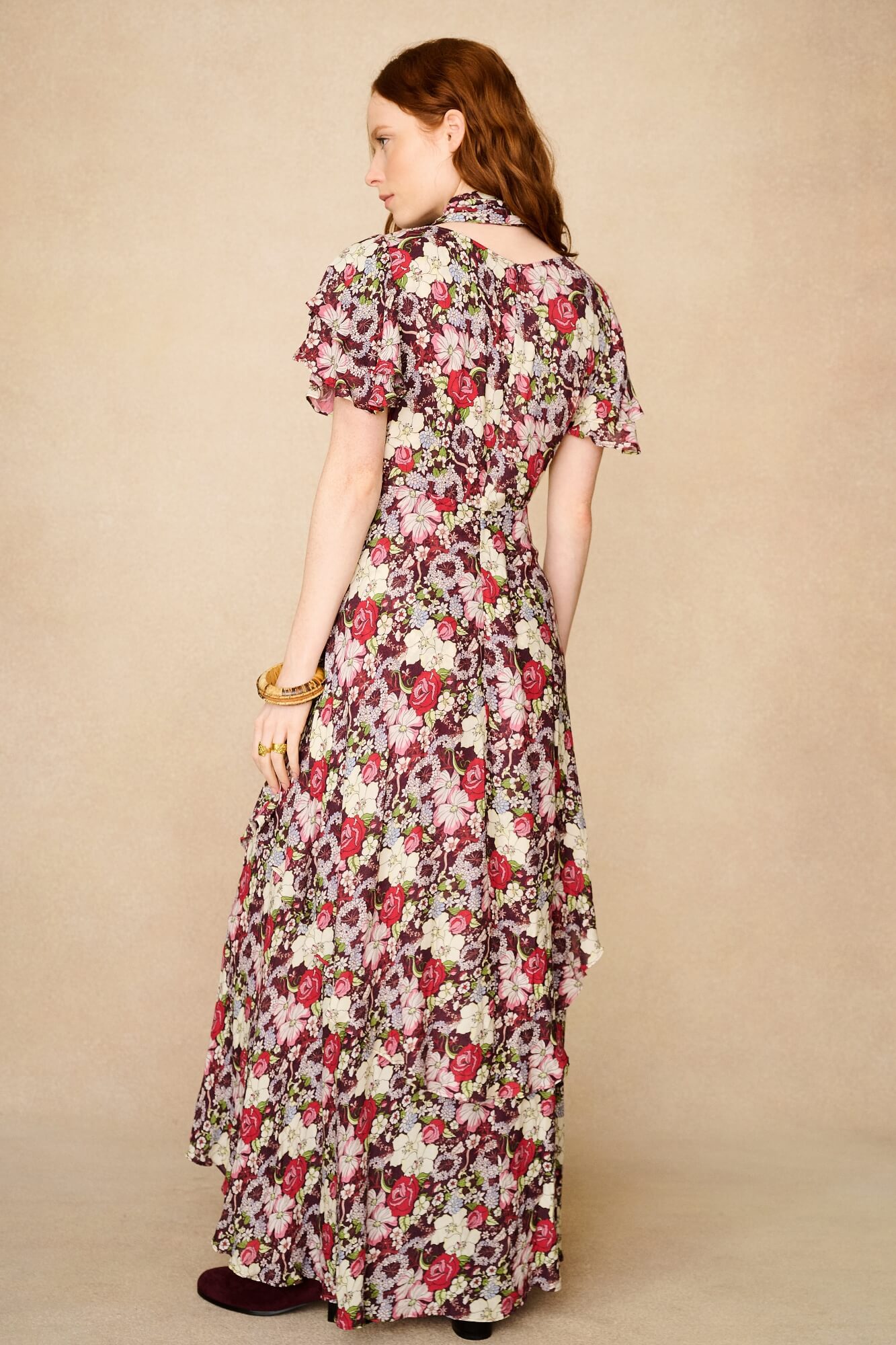woman wears floral 70s dress