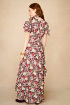 woman wears floral 70s dress
