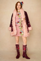 Model wearing burgundy lace-up Penny Lane boots with penny lane coat from Pamela Des Barres collection by The Hippie Shake, front view