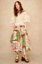 Woman wearing a floral dress with a beige background