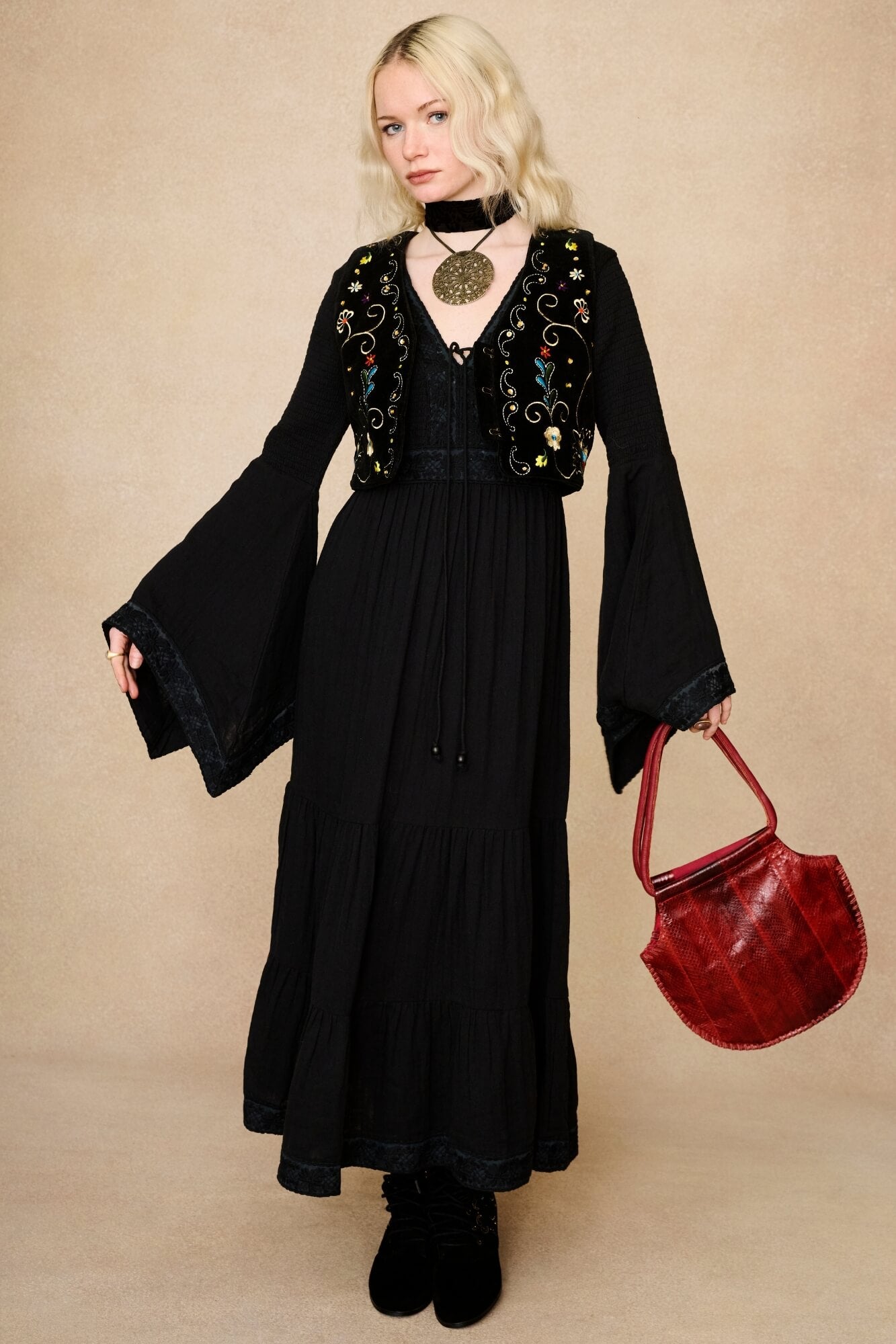 Model wearing 70s black long sleeve maxi dress with lace-up Penny Lane boots by The Hippie Shake, front view