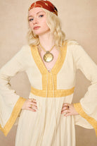 Model wearing 70s cream long sleeve maxi dress with lace-up Penny Lane boots by The Hippie Shake, close up view