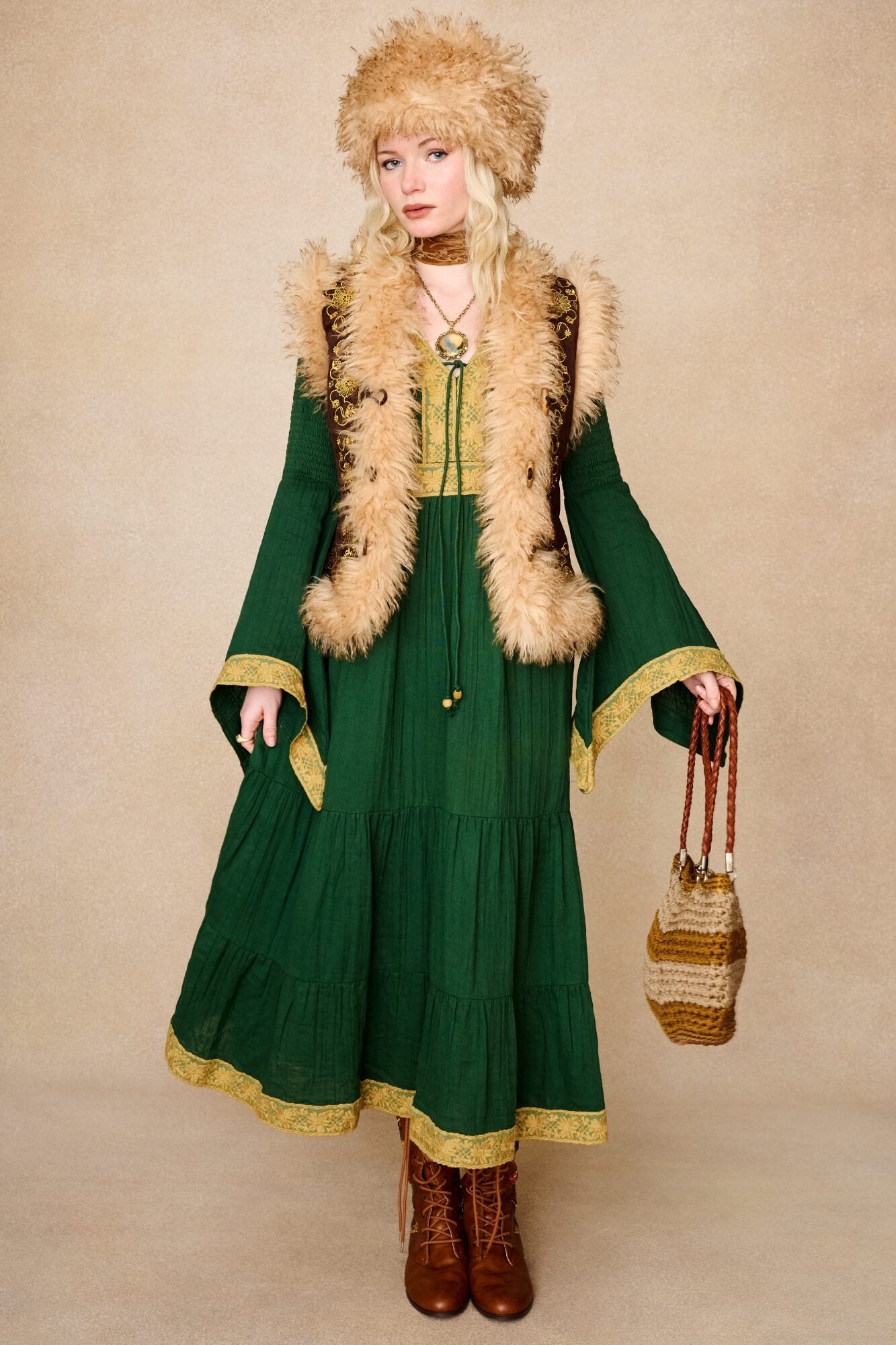 Model wearing 70s green long sleeve maxi dress with lace-up Penny Lane boots by The Hippie Shake, front view