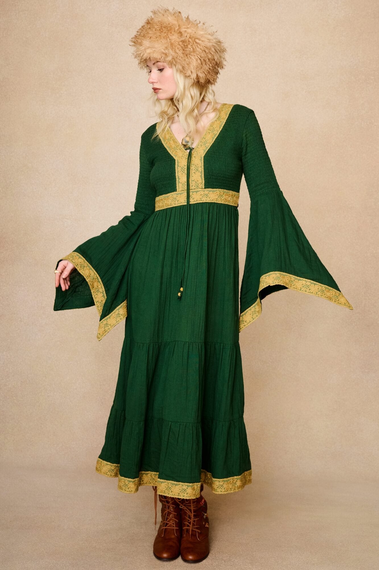 Model wearing 70s green long sleeve maxi dress with lace-up Penny Lane boots by The Hippie Shake, front view