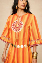 Model wearing 70s orange striped wide leg jumpsuit by The Hippie Shake, close up