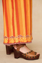 Model wearing 70s orange striped wide leg jumpsuit by The Hippie Shake, close up