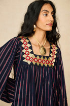 Model wearing 70s striped mini dress by The Hippie Shake, close up