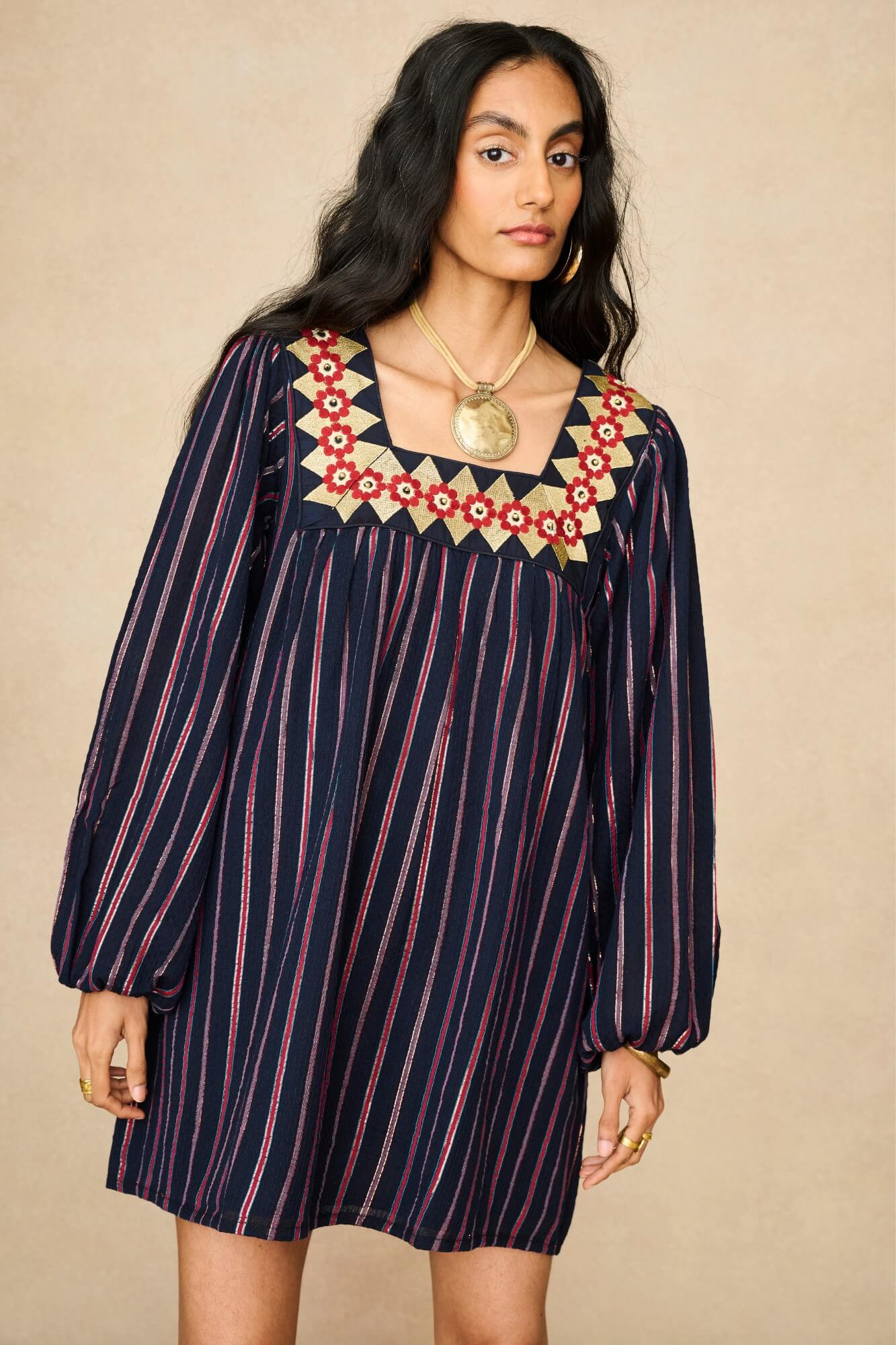 Model wearing 70s striped mini dress by The Hippie Shake, front view