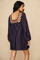 Model wearing 70s striped mini dress by The Hippie Shake, back view